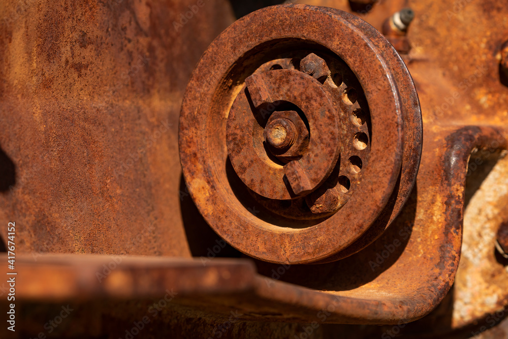 Rusty metal parts belonging to an old abandoned and disused tractor, formerly used in the agronomic industry, near Campo de Borja, Zaragoza province, Aragon, Spain.