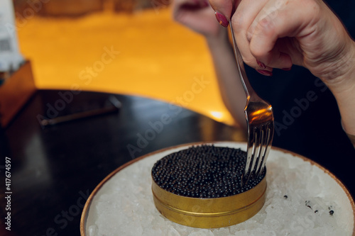 paddlefish black caviar in a plastic plate, gourmet and delicious food, close up. photo