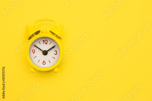 Yellow alarm clock Isolated on yellow trendy background. Rest hours time of life good morning night wake up awake concept. Space for text.