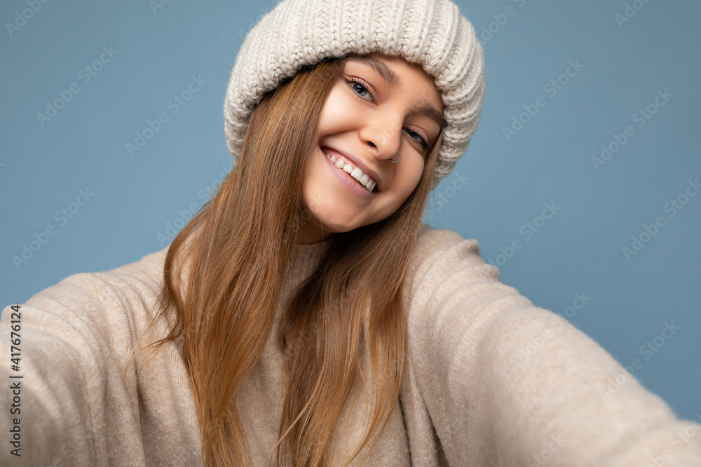 Closeup photo of attractive sexy happy smiling young dark blonde woman standing isolated over colourful background wall wearing everyday trendy clothes looking at camera showing facial emotions Closeup photo of attractive sexy happy smiling young dark blonde woman standing isolated over colourful background wall wearing everyday trendy clothes looking at camera showing facial emotions