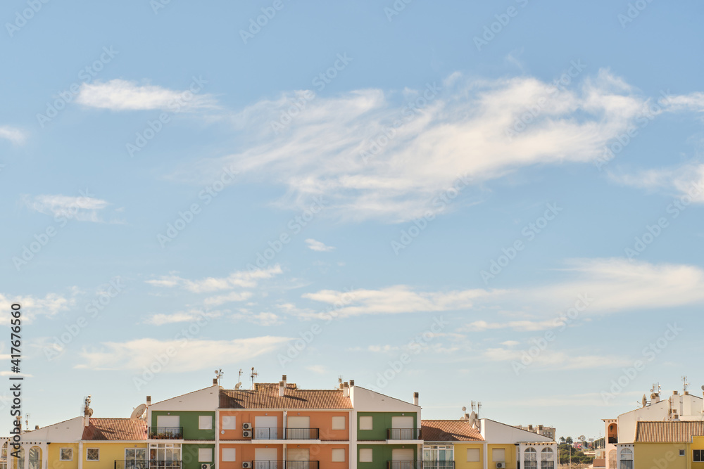 Exterior of residential building against cloudy sky background Exterior of residential building against cloudy sky background