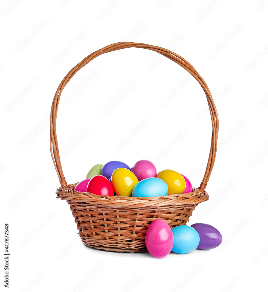 Wicker basket with bright painted Easter eggs on white background Wicker basket with bright painted Easter eggs on white background