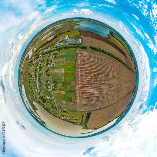 little planet 360-pano - over a plowed field near the Limansky farm near the Beysug river on a hot summer day photo