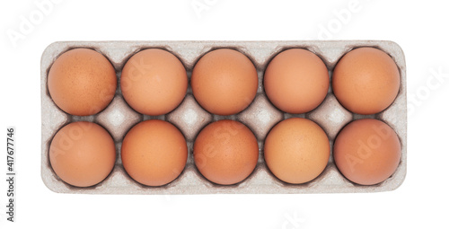 Eggs in egg carton top view isolated