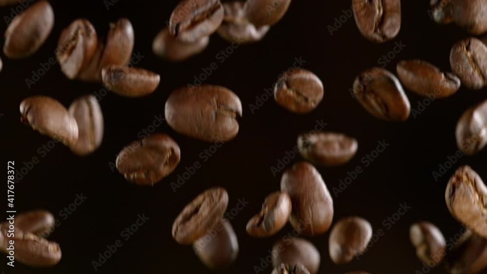 Super Slow Motion Shot of Falling Roasted Coffee Beans on Black Background at 1000fps Super Slow Motion Shot of Falling Roasted Coffee Beans on Black Background at 1000fps