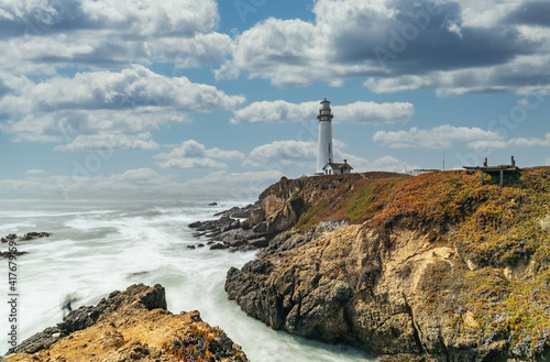 Pigeon Point Lighthouse against the backdrop of the beautiful sky and ocean with long exposure waves, a great landscape of the Pacific coast in California