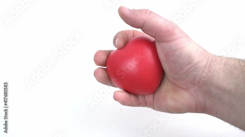 A young man works with a red hand expander on a white background photo