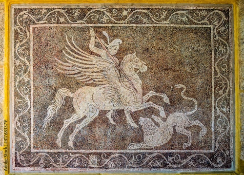 Hunter on a Pegasus horse with a spear. An ancient mosaic panel on the wall. Old Town, Rhodes, Greece.