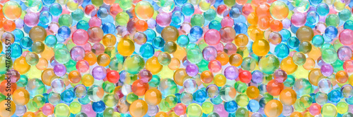 Abstract multicolored wide panoramic background with hydrogel beads texture. Water absorbent balls photo