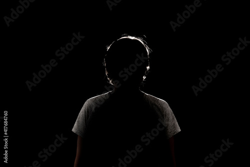 dark black background with silhouette of male woman