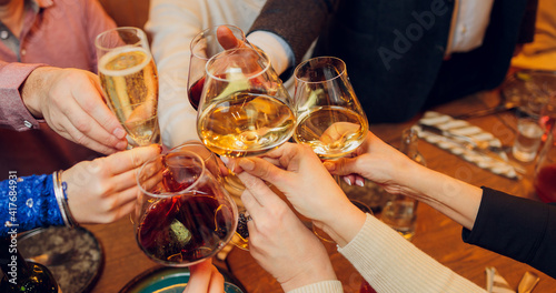 Принти на полотні Clinking glasses with alcohol and toasting, party.
