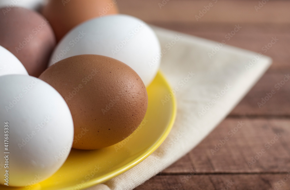 yellow plate with whole eggs on a napkin, close-up with a copy of the space yellow plate with whole eggs on a napkin, close-up with a copy of the space