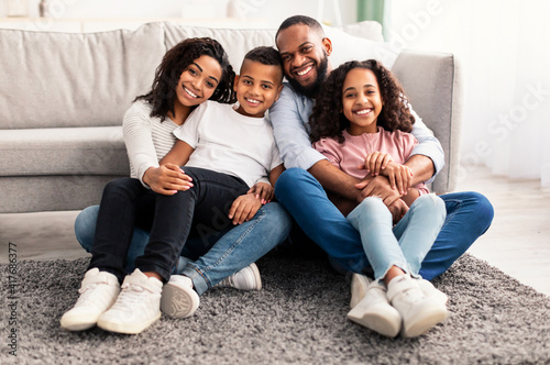 Portrait of a happy black family posing at camera