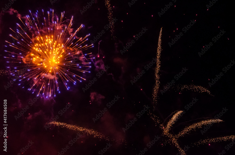 Fototapeta premium festive fireworks in the night black sky