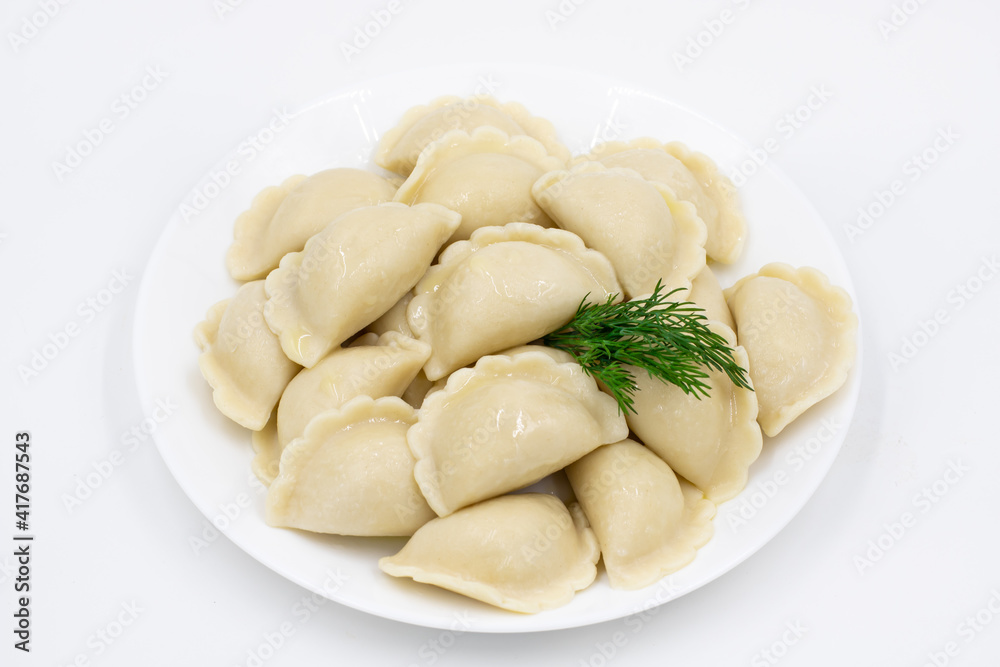 Boiled dumplings with potatoes. Traditional Ukrainian and Russian food. White background.