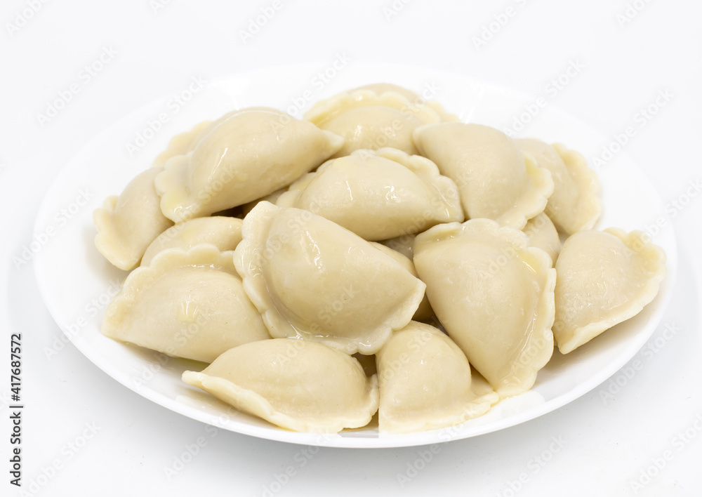 Boiled dumplings with potatoes. Traditional Ukrainian and Russian food. White background.