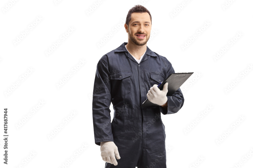 Worker in a jumpsuit standing and holding a clipboard Worker in a jumpsuit standing and holding a clipboard