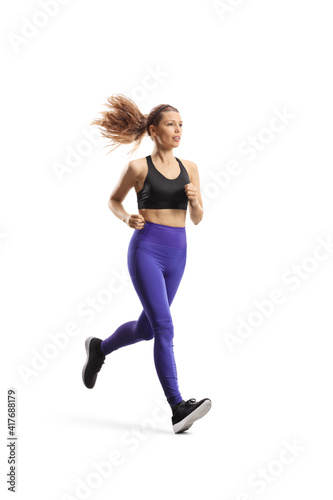 Full length shot of a slim young woman in sportswear running