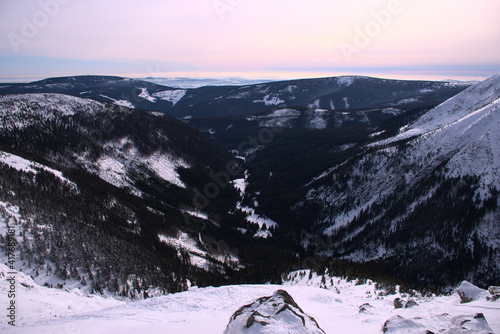 Fototapeta Naklejka Na Ścianę i Meble -  beautiful winter mountain panorama overlooking the valley, top view, dark forest, sunset