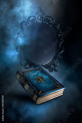 Magic vintage fantasy book on a dark background, magic mirror of predictions and fortune-telling, smoke, fog, neon moonlight in the dark. 3D illustration. 