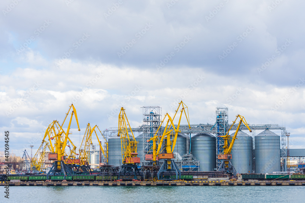 Odessa, UKRAINE - MART 1, 2021. Odessa port. Port cranes await the loading of grain from the granary. Odessa port, Odessa, Ukraine Odessa, UKRAINE - MART 1, 2021. Odessa port. Port cranes await the loading of grain from the granary. Odessa port, Odessa, Ukraine
