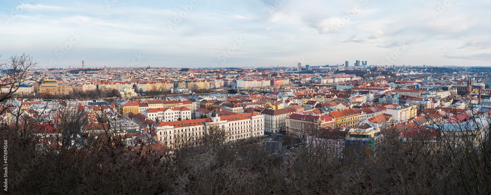 Aerial panorama view of Prague city centre cityscape and skyline with many historic and modern buildings and Vltava river, view from top of Petrin Hill. Czech Republic, winter day
