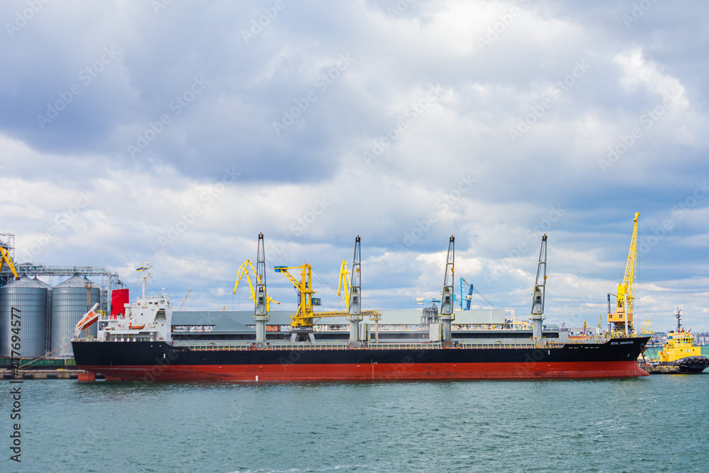 Odessa, UKRAINE - MART 1, 2021. Commercial dry cargo ship arrived at the port of Odessa to load grain. Odessa, Odessa port, Ukraine.