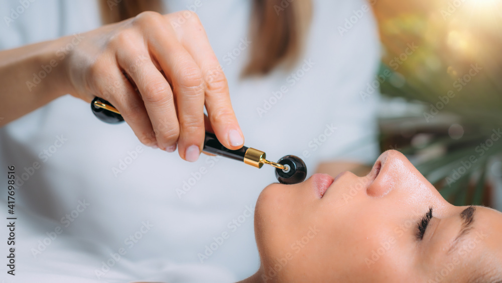 Fototapeta premium Guasha Face Massage with Jade Stone Roller