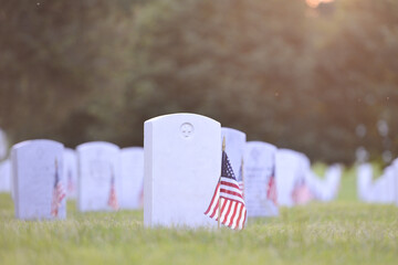 Headstones and National flags in Arlington National Cemetery - Circa Washington D.C. United States of America	