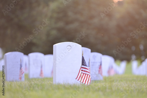 Headstones and National flags in Arlington National Cemetery - Circa Washington D.C. United States of America	