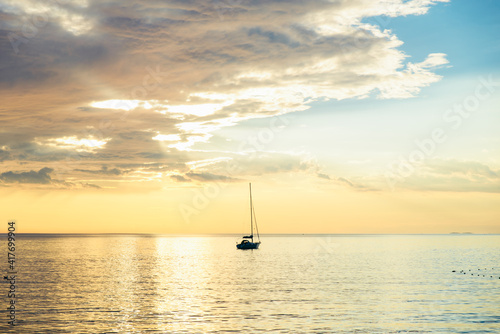 view of sail boat on sunset in bay. summer vacation © phpetrunina14