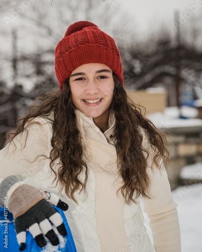 girl holding sled