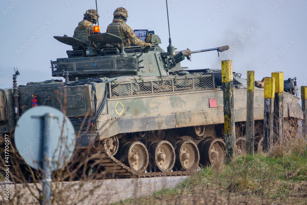 British army FV510 warrior light infantry fighting vehicle armoured tank in action on a military exercise, Wiltshire UK