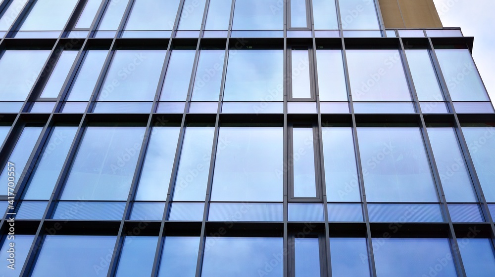 Fragment of glass and metal facade walls. Commercial office buildings. Abstract modern business architecture.