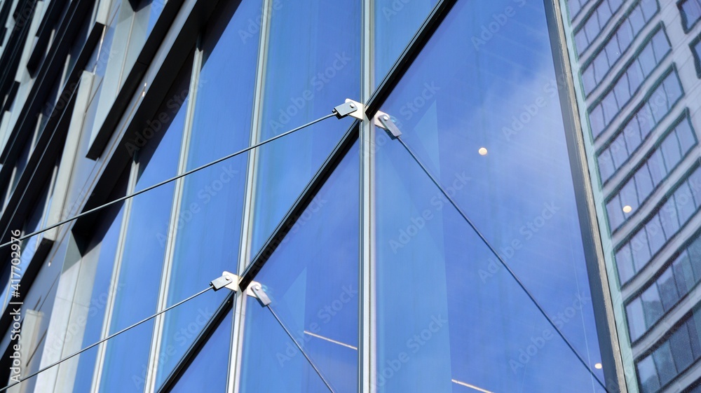 Fragment of glass and metal facade walls. Commercial office buildings. Abstract modern business architecture. Fragment of glass and metal facade walls. Commercial office buildings. Abstract modern business architecture.
