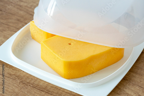 cheese pan.Cheese storage item. Concept of storing cheese in the refrigerator.