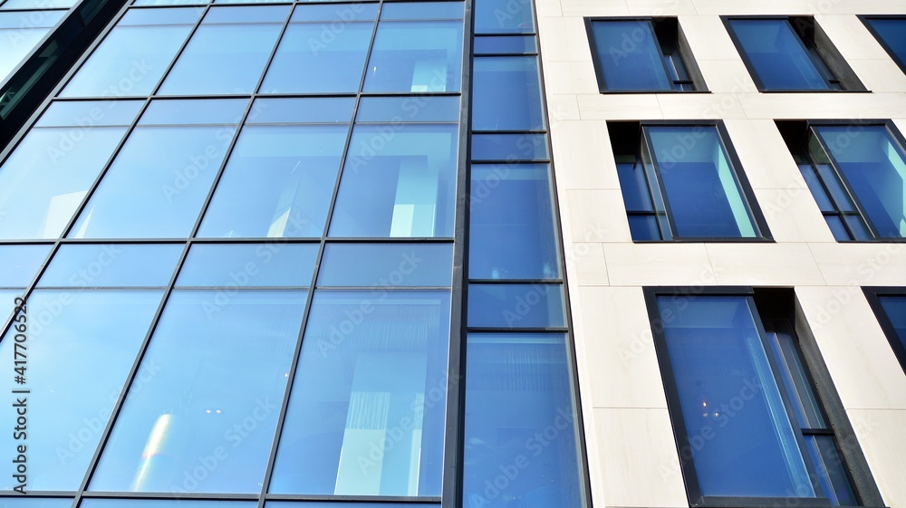 Fragment of glass and metal facade walls. Commercial office buildings. Abstract modern business architecture. Fragment of glass and metal facade walls. Commercial office buildings. Abstract modern business architecture.