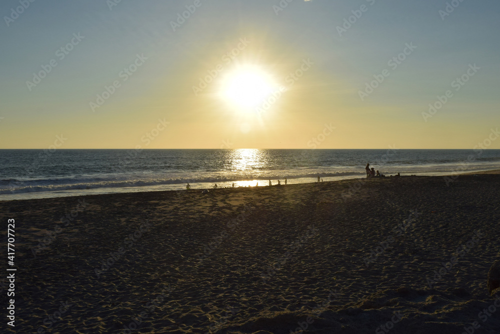 People enjoying the beautiful sunset in Ecuadro beach, Mar Bravo