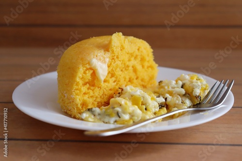 Obraz na plátně Brazilian couscous and scrambled eggs (Cuscuz com ovo) on wooden background