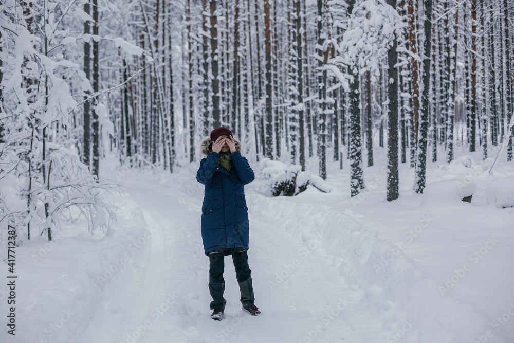 Young girl walking the winter forest