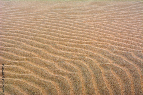 Fine beach sand in the summer sun.   Sand texture. Sandy beach for background. Top view.