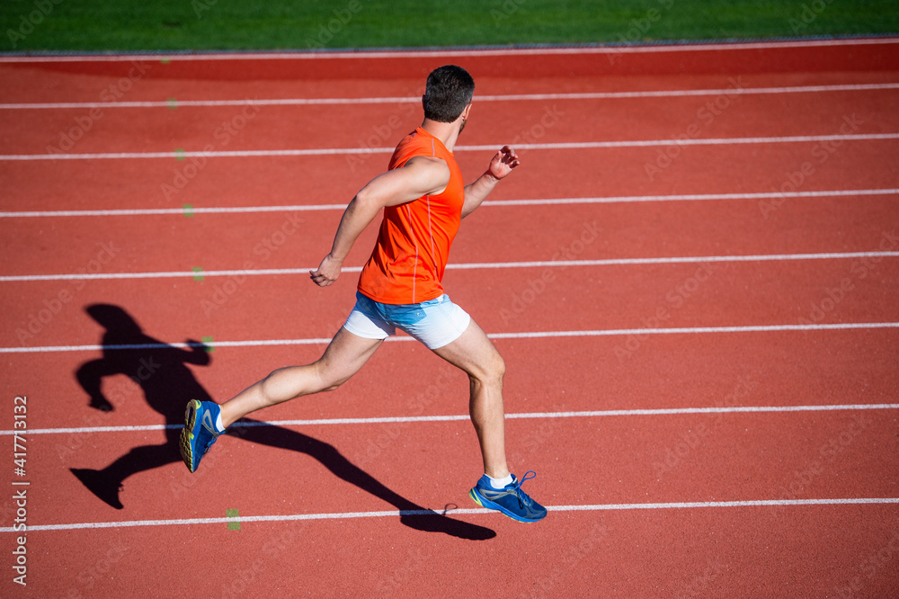 sportsman guy in sportswear run fast sprinting on running track, stamina sportsman guy in sportswear run fast sprinting on running track, stamina