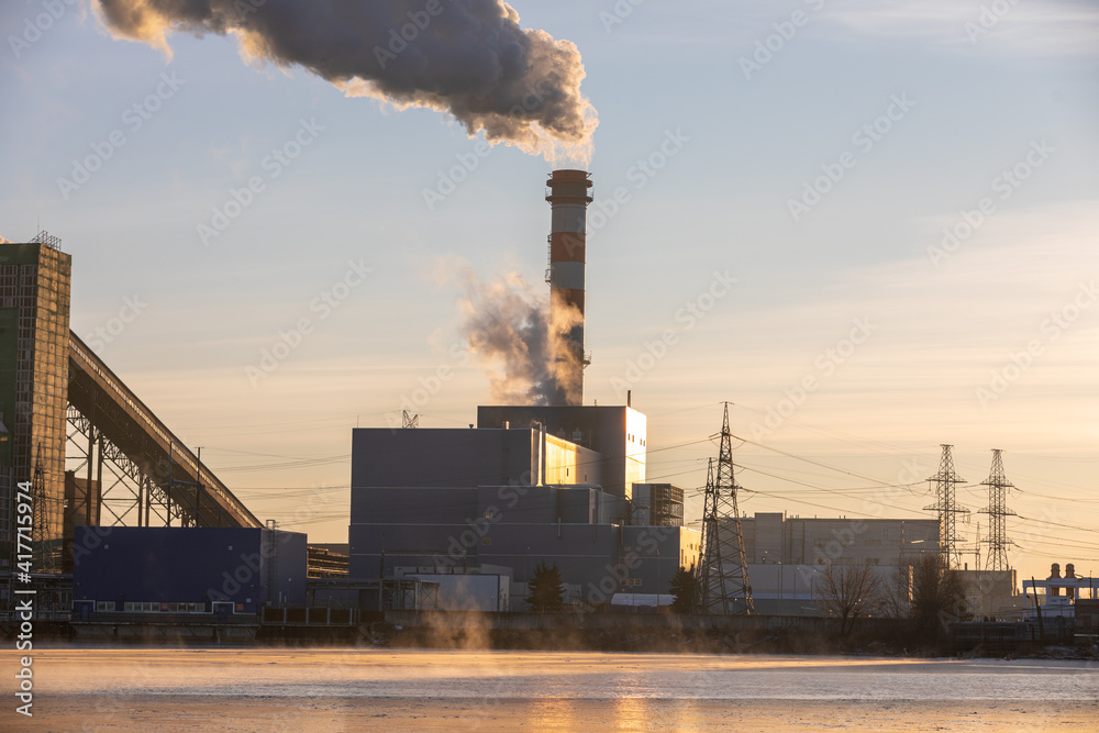 Air pollution from a natural gas and coal power plant. Emissions of harmful substances into the atmosphere. Traditional hydrocarbon energy. Electricity and heat production. Ecological concept.