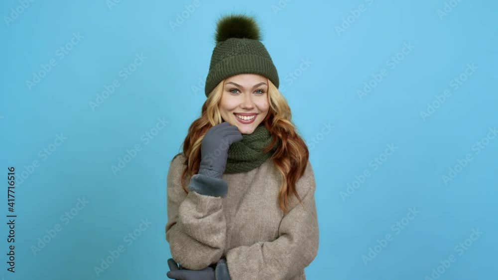 Teenager woman with winter hat standing and looking to the side over isolated background Teenager woman with winter hat standing and looking to the side over isolated background