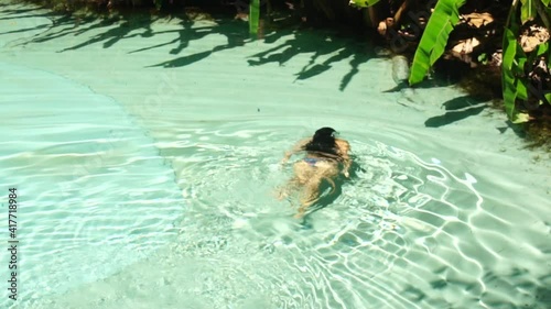 woman  swimming in the nature pool