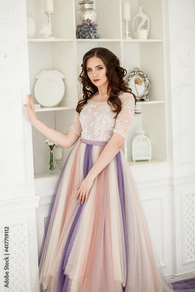 Bride in color wedding dress. Beautiful model in a beautiful wedding dress in a white photo studio. Portrait of an attractive girl in a beautiful interior. Bride in color wedding dress. Beautiful model in a beautiful wedding dress in a white photo studio. Portrait of an attractive girl in a beautiful interior.