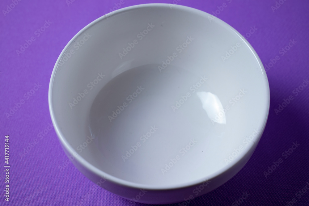 white bowl on lilac background white bowl on lilac background