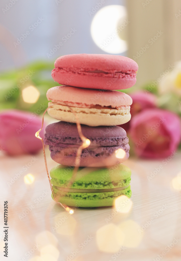 Tasty macaroons and flowers on light background Tasty macaroons and flowers on light background