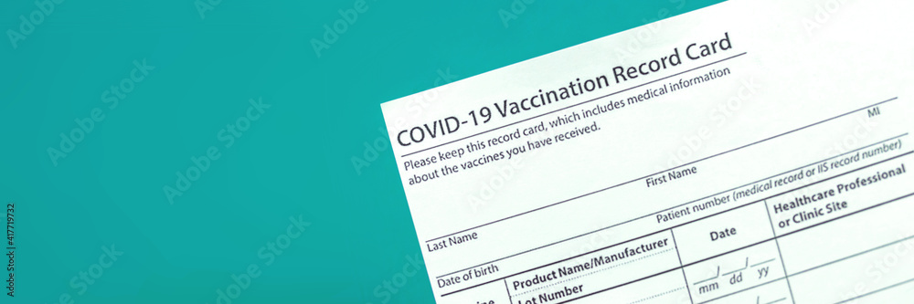 COVID-19 vaccination record card close up banner, copy space COVID-19 vaccination record card close up banner, copy space