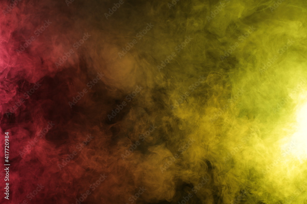 Smoke in red-yellow light on black background Smoke in red-yellow light on black background